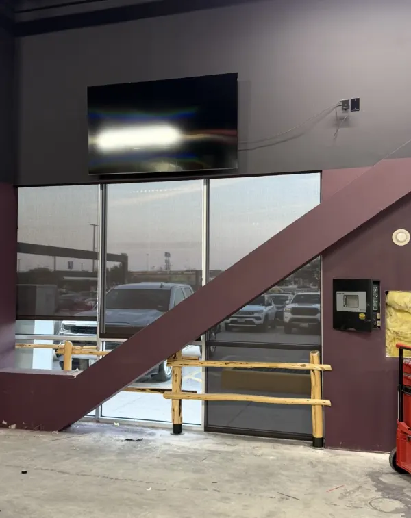 Large display mounted above a venue entrance, installed and cabled by BVTech LLC — Jordan Polasek BVTech LLC