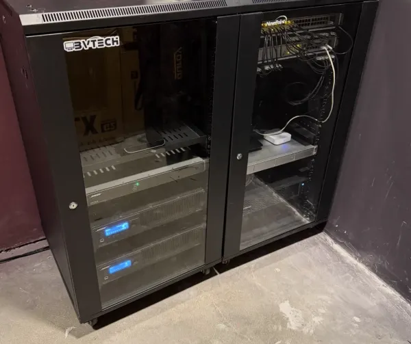 Network and AV equipment rack with patch panels, UPS units, and dressed cabling installed by BVTech LLC — Jordan Polasek BVTech LLC